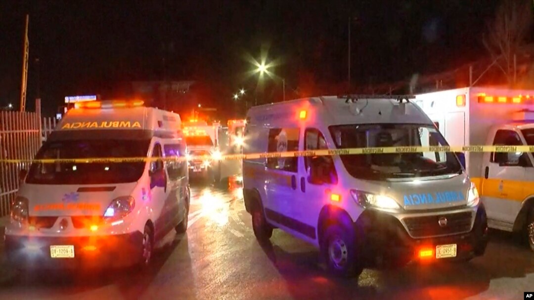 An image taken from a video shows ambulances and rescue teams staffers at the site of a fire at an immigration detention facility in Ciudad Juarez, Mexico, March 28, 2023.