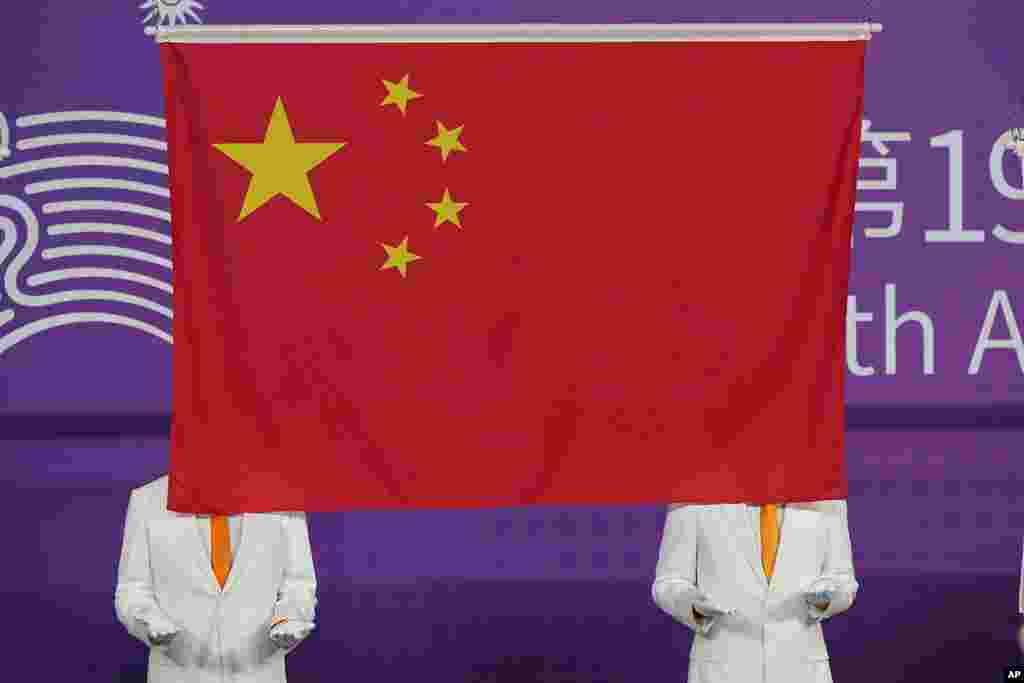 A Chinese national flag is hoisted during a medal ceremony for judo at the 19th Asian Games in Hangzhou, China.