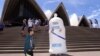 FILE - Safety Sam, The Condom Man, distributes free condoms on the steps of the Sydney Opera House, Feb. 20, 1999.
