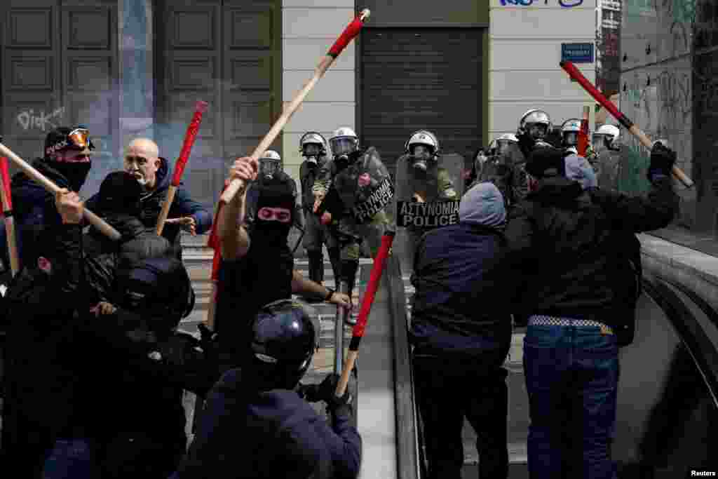 Protesters clash with riot police during a demonstration following the collision of two trains, near the city of Larissa, in Athens, Greece.