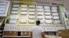 FILE - A man looks at a a wall displaying air conditioning models on sale at department store, in Rome, July 25, 2023.