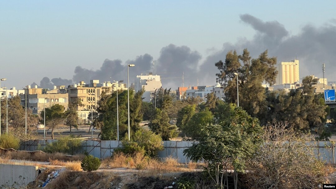 Smoke rises amid clashes between armed factions, in Tripoli, Libya, Aug. 15, 2023.