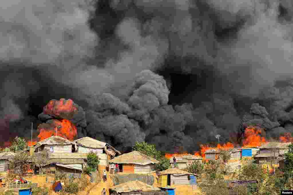 Fire burns in the Rohingya refugee camp in Balukhali in Cox's Bazar, Bangladesh.