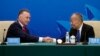 Australia's former Trade Minister Craig Emerson and China's former Foreign Minister Li Zhaoxing shake hands at the China-Australia High Level Dialogue in Beijing, Sept. 7, 2023. Australian Prime Minister Anthony Albanese's coming visit to China is a sign of improving relations. 