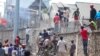 Congolese protesters scale the perimeter wall of the compound of United Nations peacekeeping force's warehouse in Goma, in the North Kivu province of the Democratic Republic of Congo, July 26, 2022.
