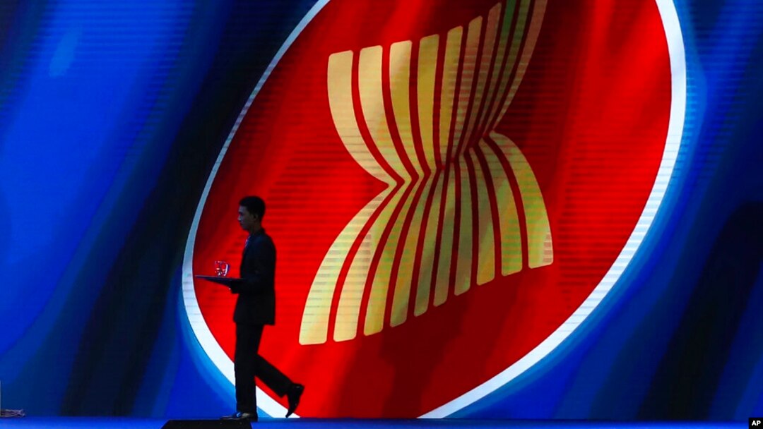 FILE - A steward walks past the ASEAN logo during the ASEAN Business and Investment Summit, a parallel event to the ASEAN summit, in Nonthaburi, Thailand, Nov. 2, 2019.