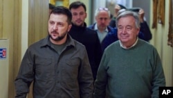 FILE - In this image provided by the Ukrainian Presidential Press Office, Ukrainian President Volodymyr Zelenskyy, left, and U.N. Secretary-General Antonio Guterres walk in a hallway during their meeting in Kyiv, Ukraine, April 28, 2022.