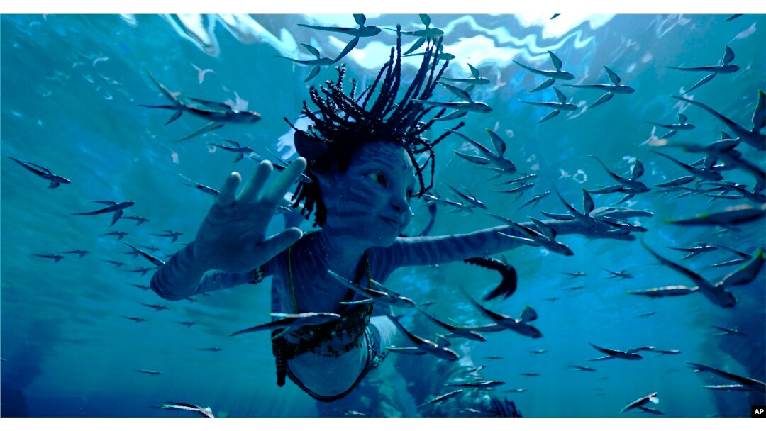 This image released by 20th Century Studios shows Trinity Bliss, as Tuk, in a scene from "Avatar: The Way of Water."