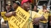 Supporters of the African National Congress President Cyril Ramaphosa hold placards and chant slogans during a demonstration against South African President Jacob Zuma outside ANC party headquarters in Johannesburg, South Africa, Feb. 5, 2018.