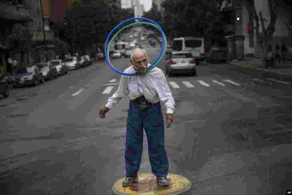 Jose Bestilleiro, from Spain, performs for tips at an street intersection in downtown Caracas, Venezuela.