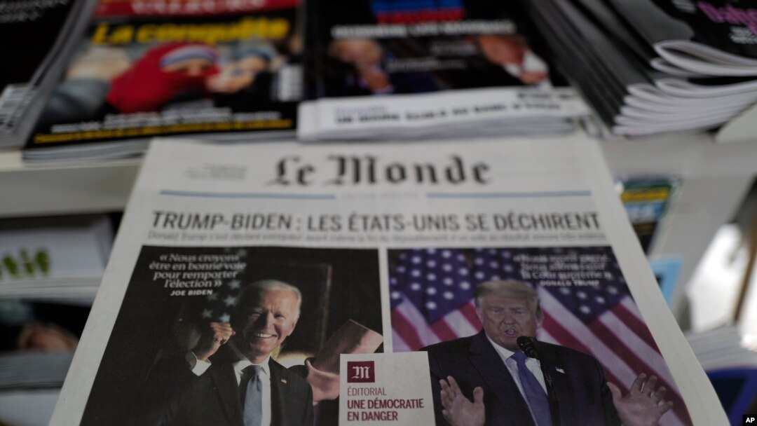 Copies of the French newspaper Le Monde with the headline "Trump-Biden: The United States Is Tearing Itself Apart" is seen at a newspaper stand in Paris, France, Nov. 4, 2020. 