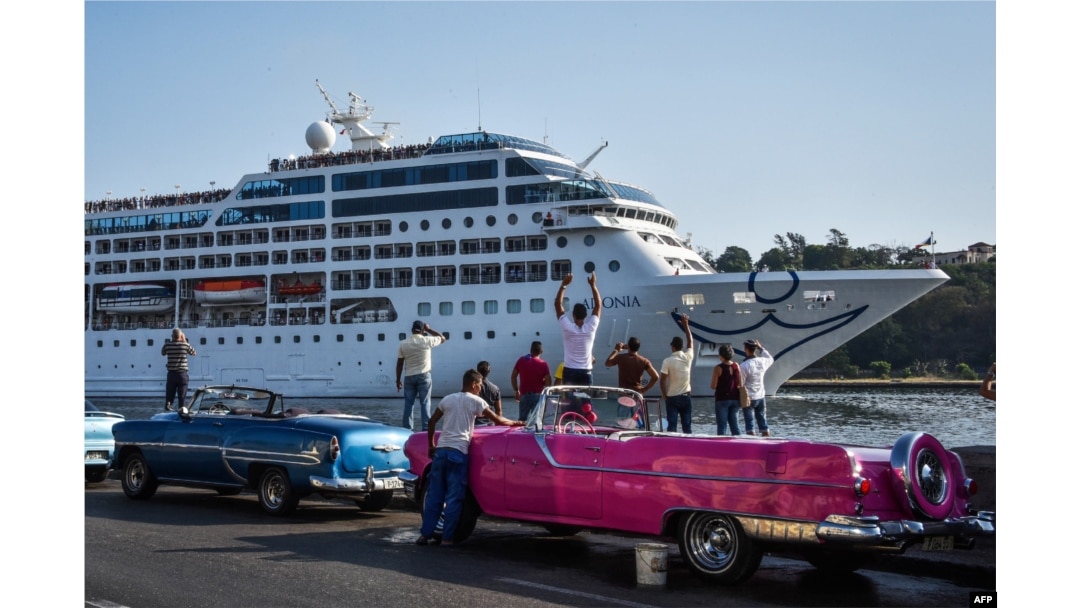 FILE - Cubans watch as the first US-to-Cuba cruise ship to arrive in the island nation in decades glides into the port of Havana, on May 2, 2016.