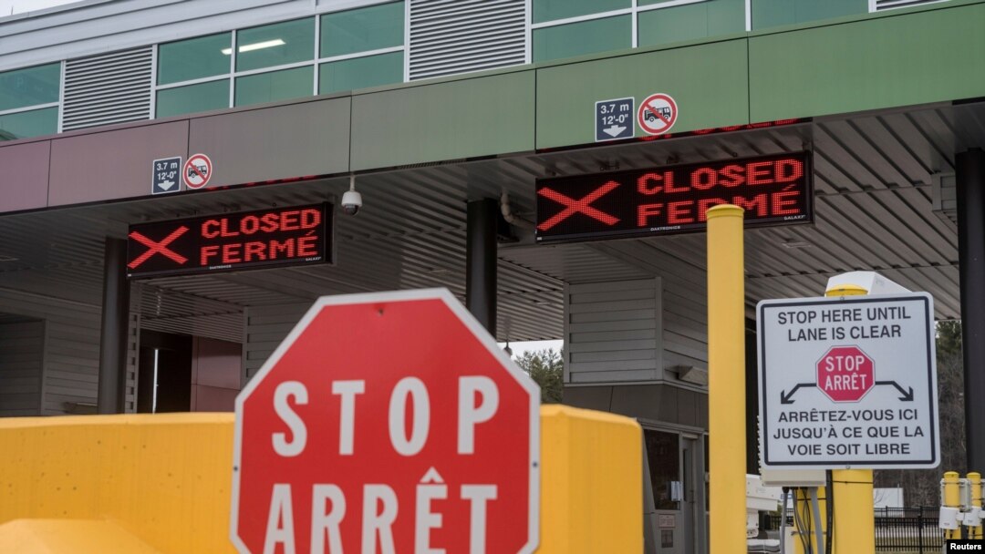 FILE - Two closed Canadian border checkpoints are seen after it was announced that the border would close to 'non-essential traffic', US-Canada border crossing at the Thousand Islands Bridge in Lansdowne, Canada, March 19, 2020.