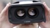 FILE - A girl wears a virtual reality headset outside the Great Hall of the People in Beijing after the opening session of the Chinese People's Political Consultative Conference in Beijing, China, March 3, 2016. 