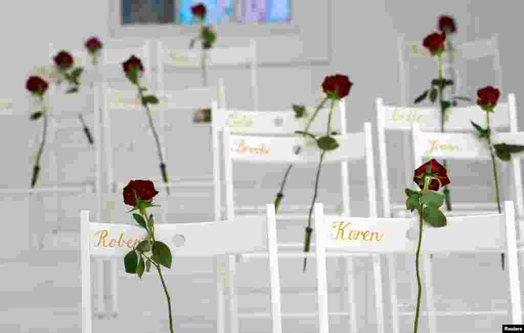 Chairs and roses show where people were found dead at the First Baptist Church of Sutherland Springs, Texas, Nov. 12, 2017. Hundreds of mourners crowded into the tiny town for the first Sunday service since a gunman stormed the church a week earlier, killing more than 26 people in the worst mass shooting in Texas history.