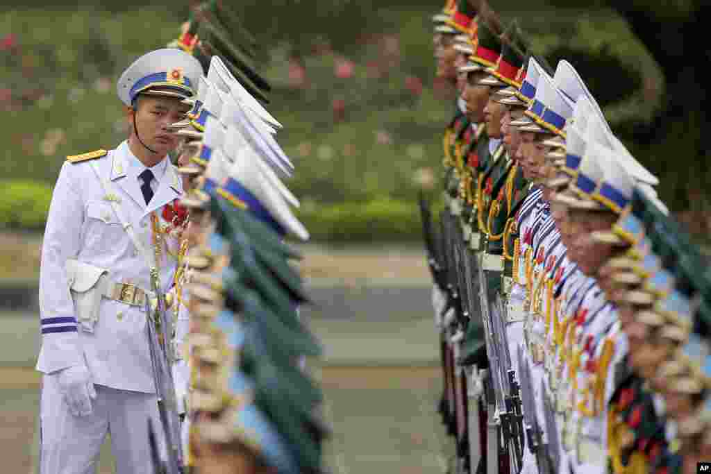 A member of the honor guard checks the line before the welcome ceremony of U.S. President Donald Trump at the Presidential Palace in Hanoi, Vietnam.