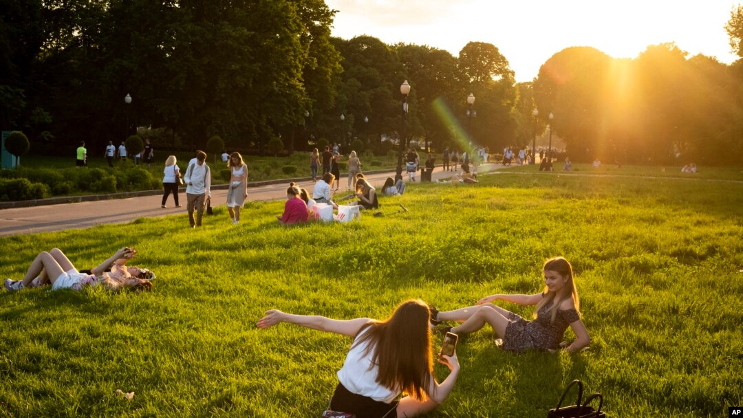 People enjoy the warm weather at Gorky Park during sunset in Moscow, Russia, June 7, 2020, as the authorities have eased the tight lockdown restrictions introduced in late March, due to the outbreak of coronavirus.