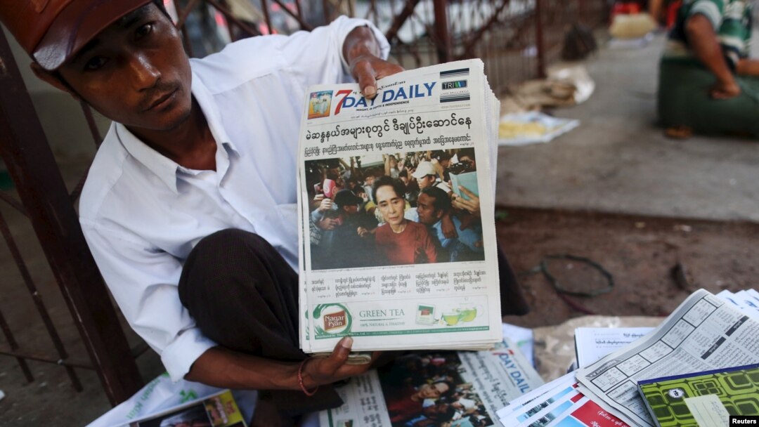 A news vendor displays local newspapers on a street in Yangon November 9, 2015. Voting unfolded smoothly in Myanmar on Sunday with no reports of violence to puncture a mood of jubilation marking the Southeast Asian nation's first free nationwide election 