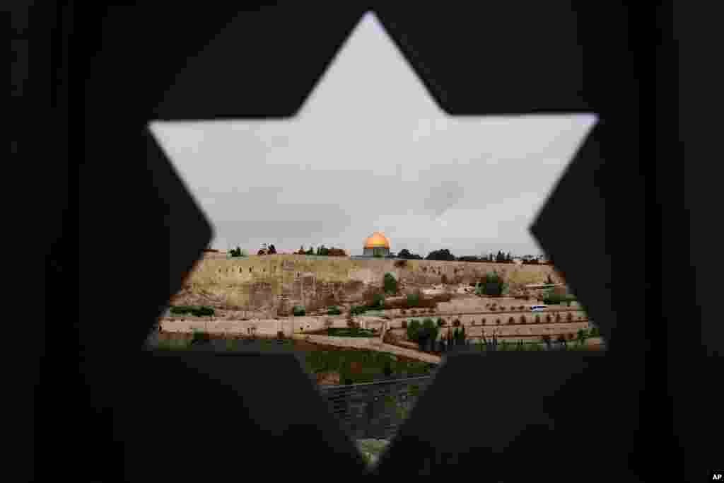 Jerusalem Old City is seen trough a door with the shape of star of David, in Jerusalem.