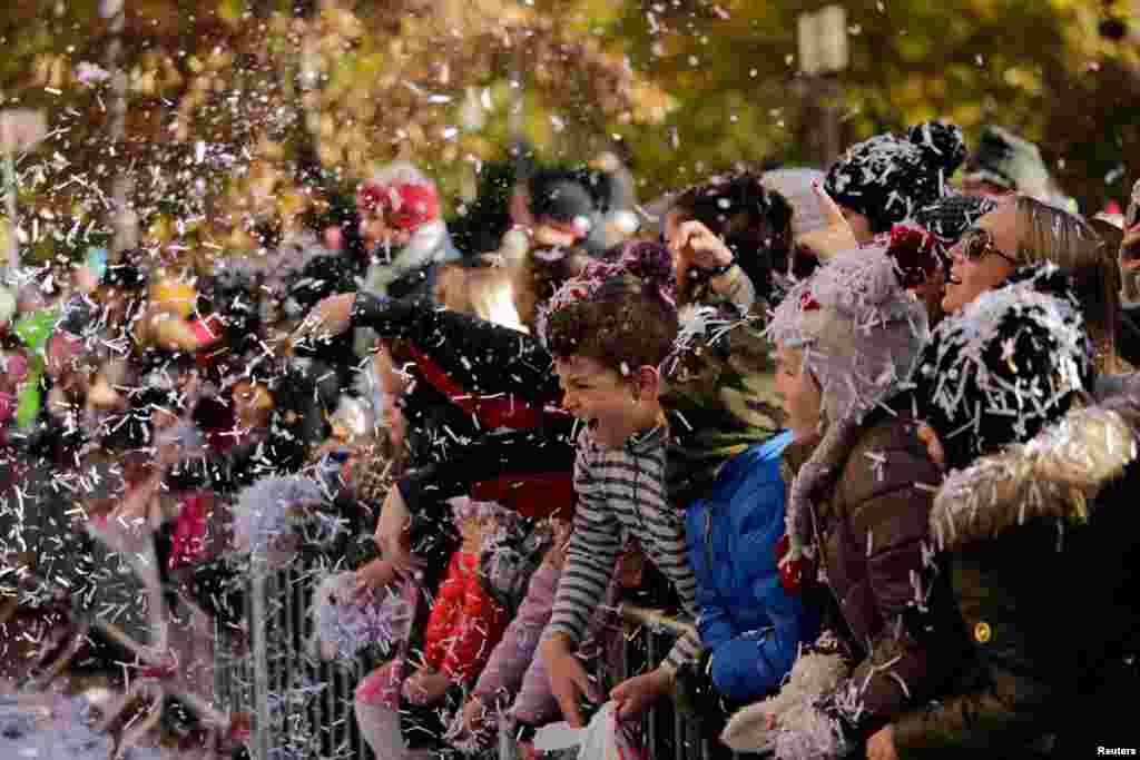People watch the 91st Macy's Thanksgiving Day Parade in the Manhattan borough of New York City.