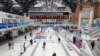 A man pushes his bicycle across the concourse of Liverpool Street railway station during morning rush hour, London, Britain, June 3, 2020. 