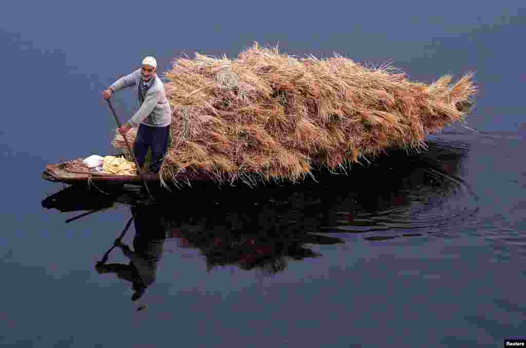 A man rows his boat filled with straw on the waters of Nageen Lake on a cold morning in Srinagar, India.