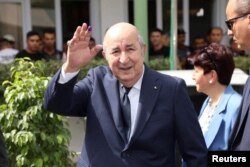 Algerian President and presidential candidate Abdelmadjid Tebboune gestures outside a polling station during the presidential election in Algiers on Sept. 7, 2024. (Algerian Presidency via Reuters)