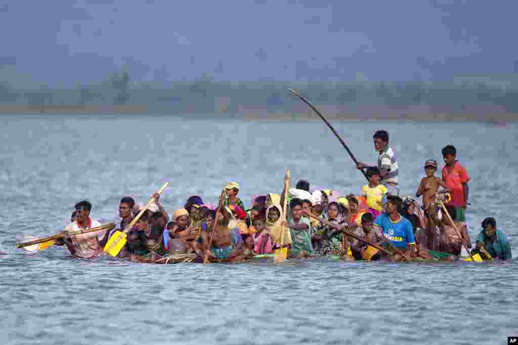 Rohingya Muslims cross over the Naf river on a raft made with plastic containers near Shah Porir Dwip, Bangladesh.