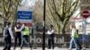 Police officers and building workers are seen outside St Thomas' Hospital in London after British Prime Minister Boris Johnson was admitted with persistent coronavirus (COVID-19) symptoms, London, April 6, 2020. 