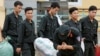 Một cảnh sát cúi lạy dân Đồng Tâm sau khi được thả ngày 22 tháng Tư. (Hình: REUTERS/Kham)