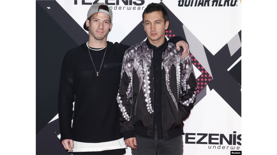 FILE - Twenty One Pilots pose on the red carpet during the MTV EMA awards at the Assago forum in Milan, Italy.