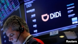 资料照片：2021 年 6 月 30 日，一名交易员在中国网约车公司滴滴全球 (Didi Global Inc) 在纽约证券交易所 (NYSE) 的首次公开募股期间工作。