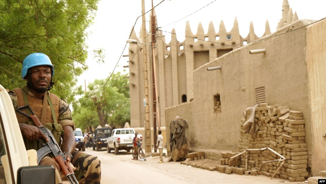 FILE - A peacekeeper with the United Nations patrols outside the mosque in Mopti, central Mali, May 30, 2018. Attackers raided a village in the central Mopti region Tuesday, killing 37 civilians, according to reports.