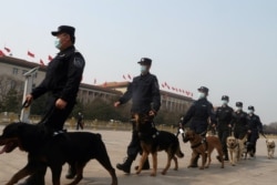 易富贤说，一个国家人口越老，政权越稳。图为中国两会期间警察在北京天安门广场巡逻。（2021年3月8日资料照）