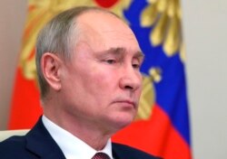 Russian President Vladimir Putin chairs a meeting with members of the government via teleconference call at Novo-Ogaryovo state residence, outside Moscow, Russia, on January 13, 2021.