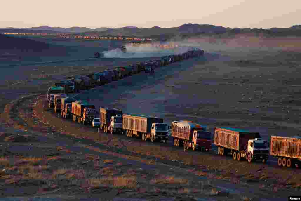 Thousands of heavy-duty trucks loaded with coal are lined up for up to 130 kilometers from the Mongolia-China border in the Gobi desert, Mongolia.