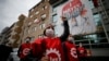 A demonstrator, wearing a face mask and shield for protection againstcoronavirus, chants slogans during May Day protests in Istanbul, May 1, 2020.
