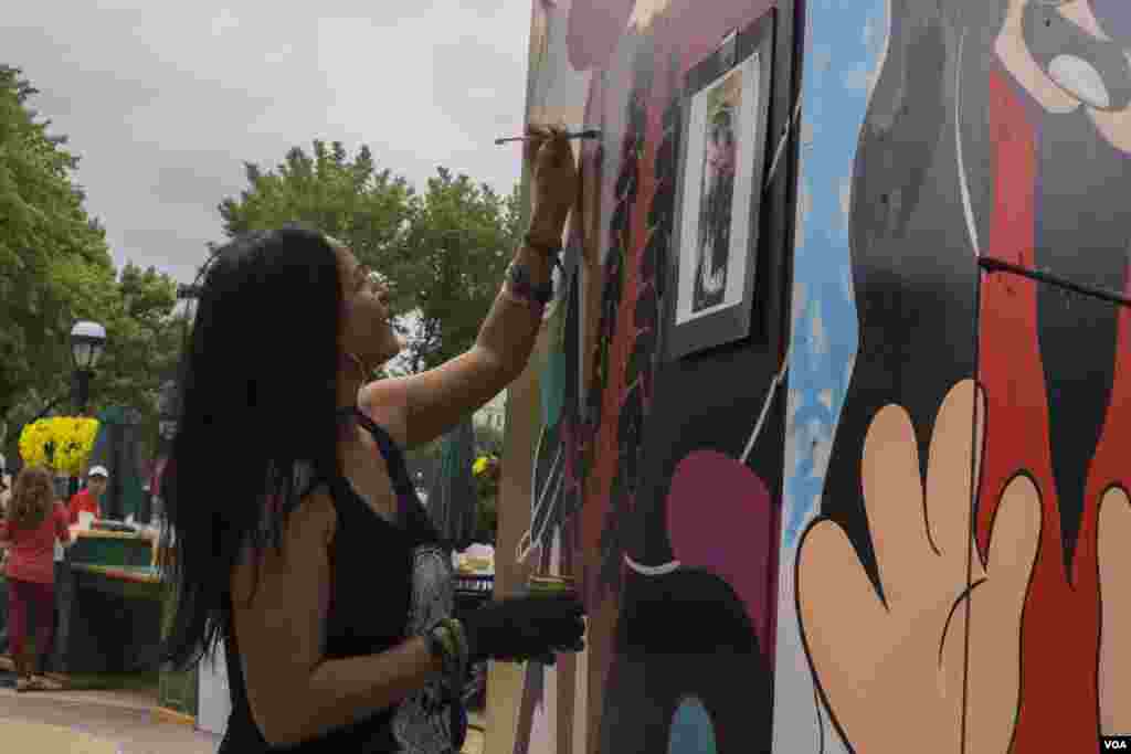 Artist and designer Cita Sadeli works on a live painting. The piece she is working on blends the styles of contemporary urban women and ornamentation found on dancers in Java, Indonesia, where Sadeli’s family is from. (T. Hart/VOA)