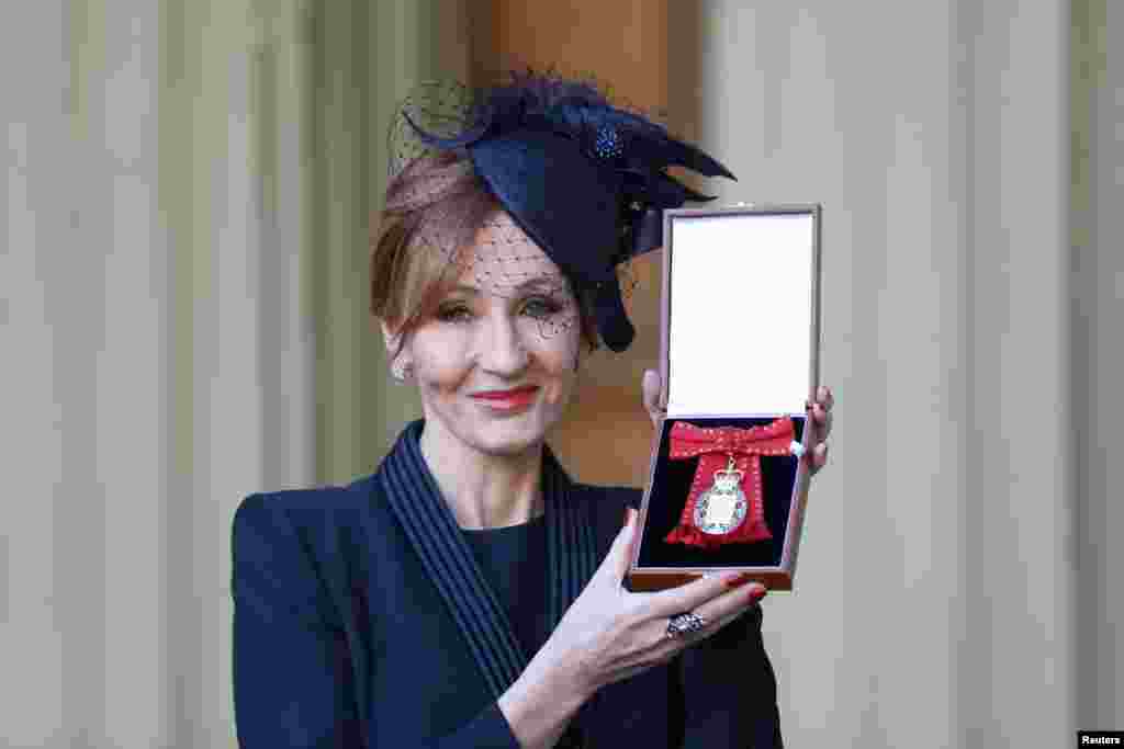 JK Rowling poses for pictures after she was made a Companion of Honour by Britain's Prince William during an Investiture ceremony at Buckingham Palace, in London.