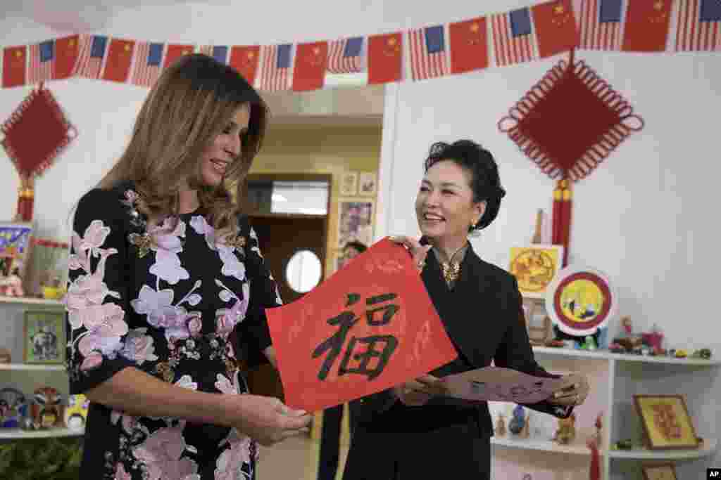 美国第一夫人梅拉尼娅&middot;特朗普和中国国家主席习近平夫人彭丽媛访问北京板厂小学，两人手持学生写的福字（2017年11月9日）。