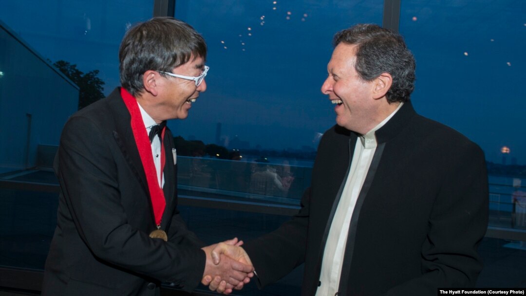 Toyo Ito, left, receives the 2013 Pritzker Architecture Prize from Thomas J. Pritzker, at ceremonies in Boston, May 29, 2013.