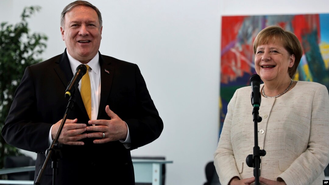 U.S. Secretary of State, Mike Pompeo, left, and German Chancellor Angela Merkel address the media during a joint statement before a meeting at the chancellery in Berlin, May 31, 2019.