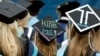 FILE - Graduates, including one looking for a job, are seated during George Washington University's commencement exercises on the National Mall in Washington, May 17, 2015.