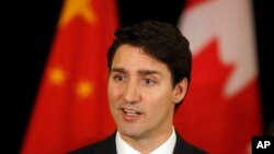 FILE - Canadian Prime Minister Justin Trudeau speaks to the media at a Beijing hotel, during a trip to China, Dec. 5, 2017.