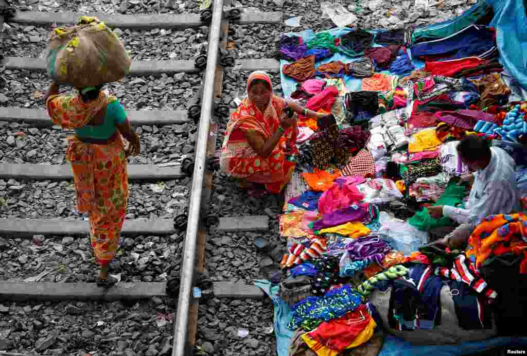 A woman shops beside a railway track in Kolkata, India.