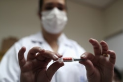 A nurse holds the China’s SinoVac coronavirus potential vaccine for trials before administering it to a volunteer at Emilio Ribas Institute in Sao Paulo, Brazil, July 30, 2020. Picture taken July 30, 2020. REUTERS/Amanda Perobelli