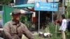 A man driving a motor passing Yim Sokhoeun’s house where a Cambodian People’s Party’s sign bearing the party logo stands in front. “It’s not good unless there is an opposition party,” said Sokhoeun, Jan. 10, 2018. (Sun Narin/VOA Khmer)