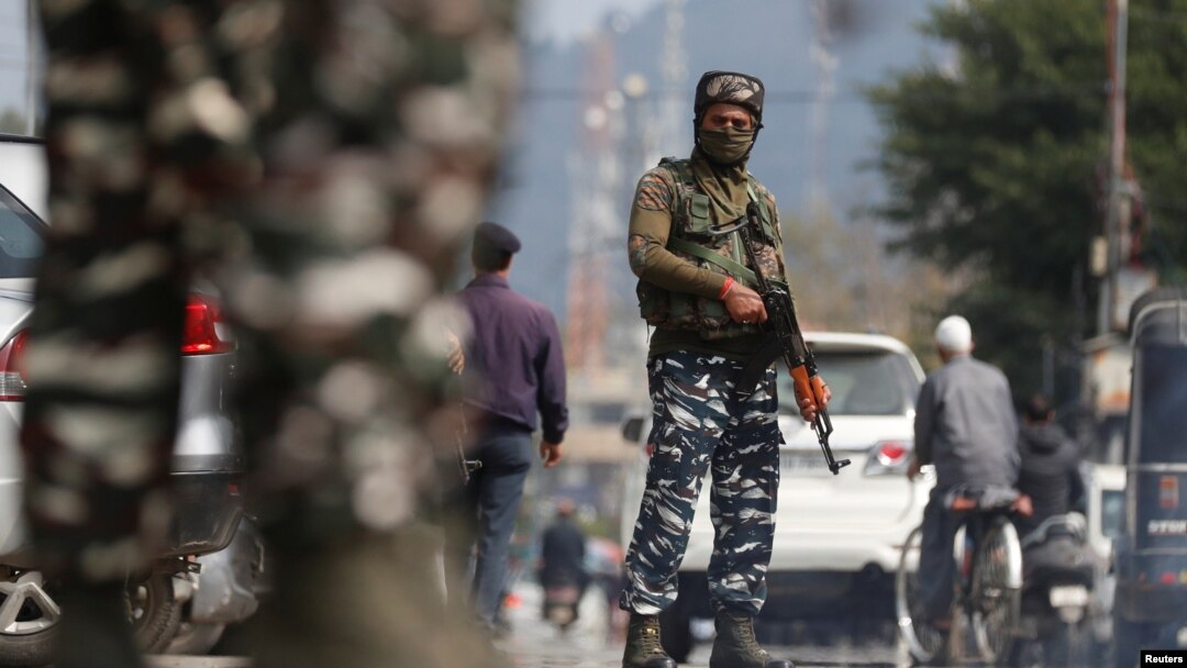 Indian Central Reserve Police Force personnel stand guard on a street in Srinagar, October 12, 2021. 
