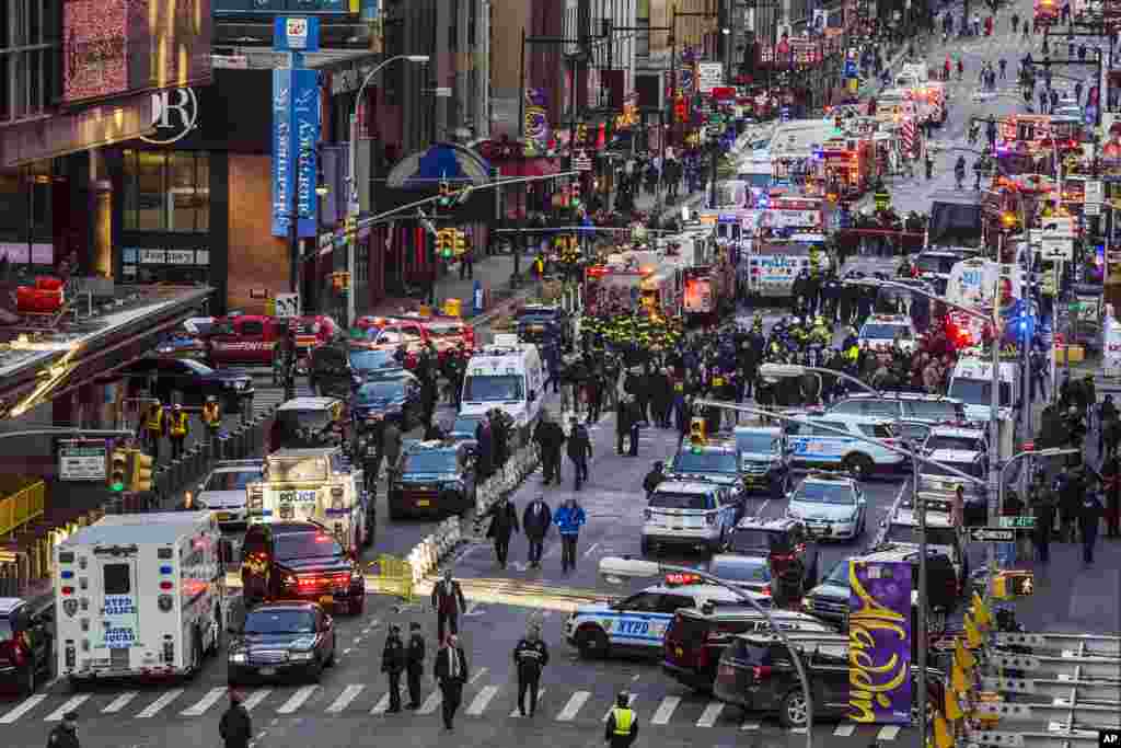 Law enforcement officials work following an explosion near New York's Times Square. Police said a man with a pipe bomb strapped to his body set off the crude device in a passageway under 42nd Street between Seventh and Eighth Avenues.