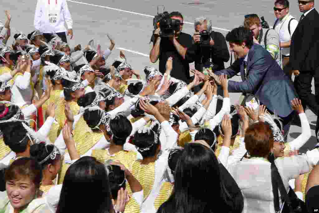 Canadian Prime Minister Justin Trudeau greets performers upon arrival at Clark International Airport in Clark, Pampanga province north of Manila, Philippines.